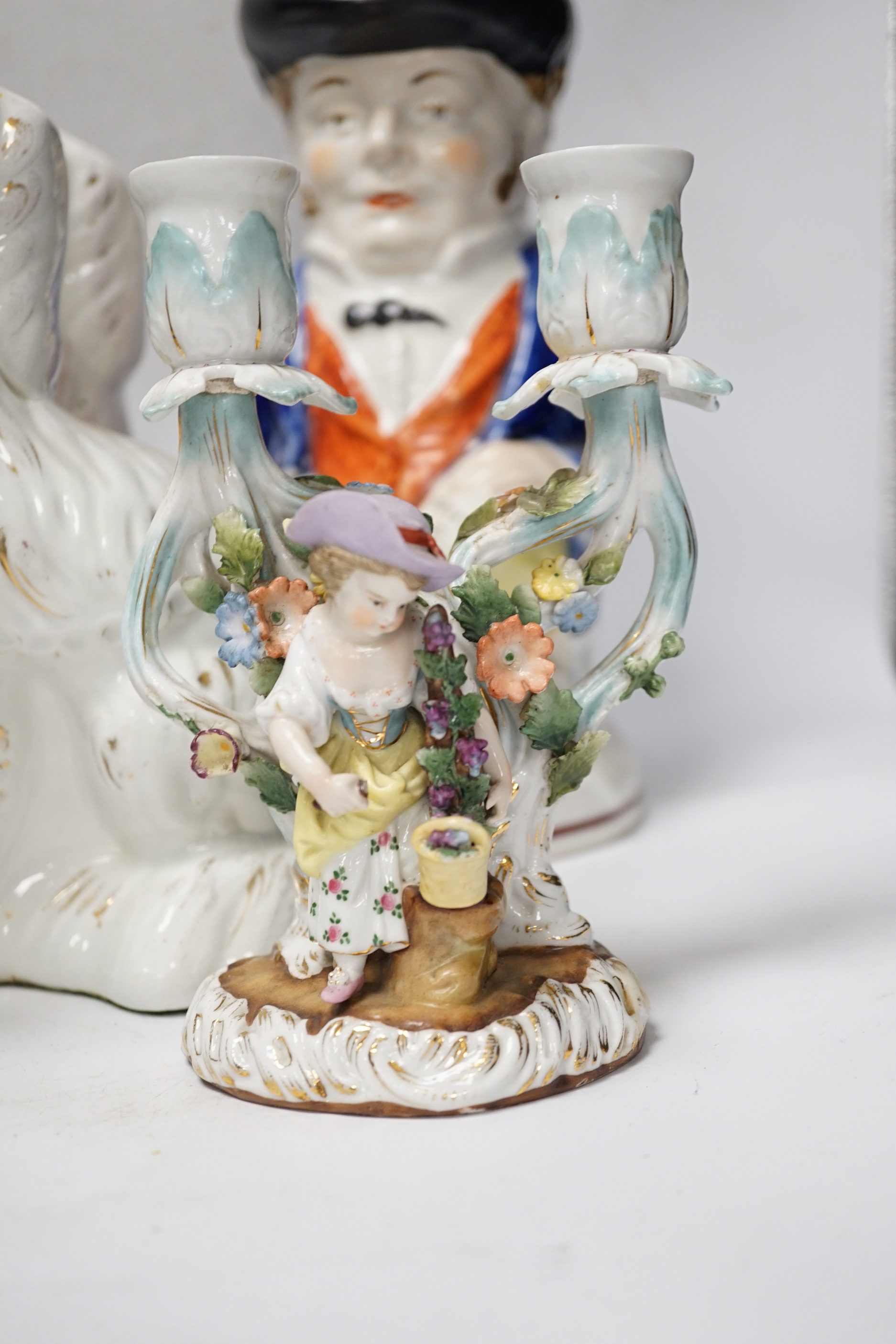 A pair of 19th century French figural two branch candelabra, 17cm high, together with two Staffordshire character jugs and a pair of Kings Charles Spaniel figures